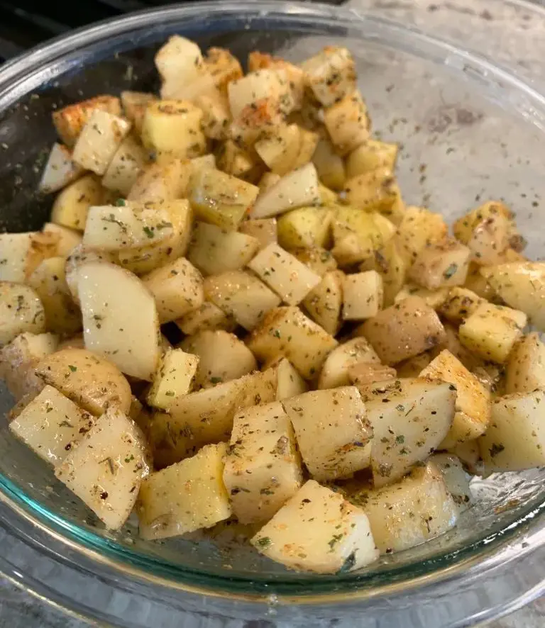 seasoned cubed potatoes in bowl