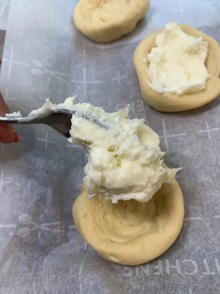 placing cream cheese mixture the center of the crescent rolls