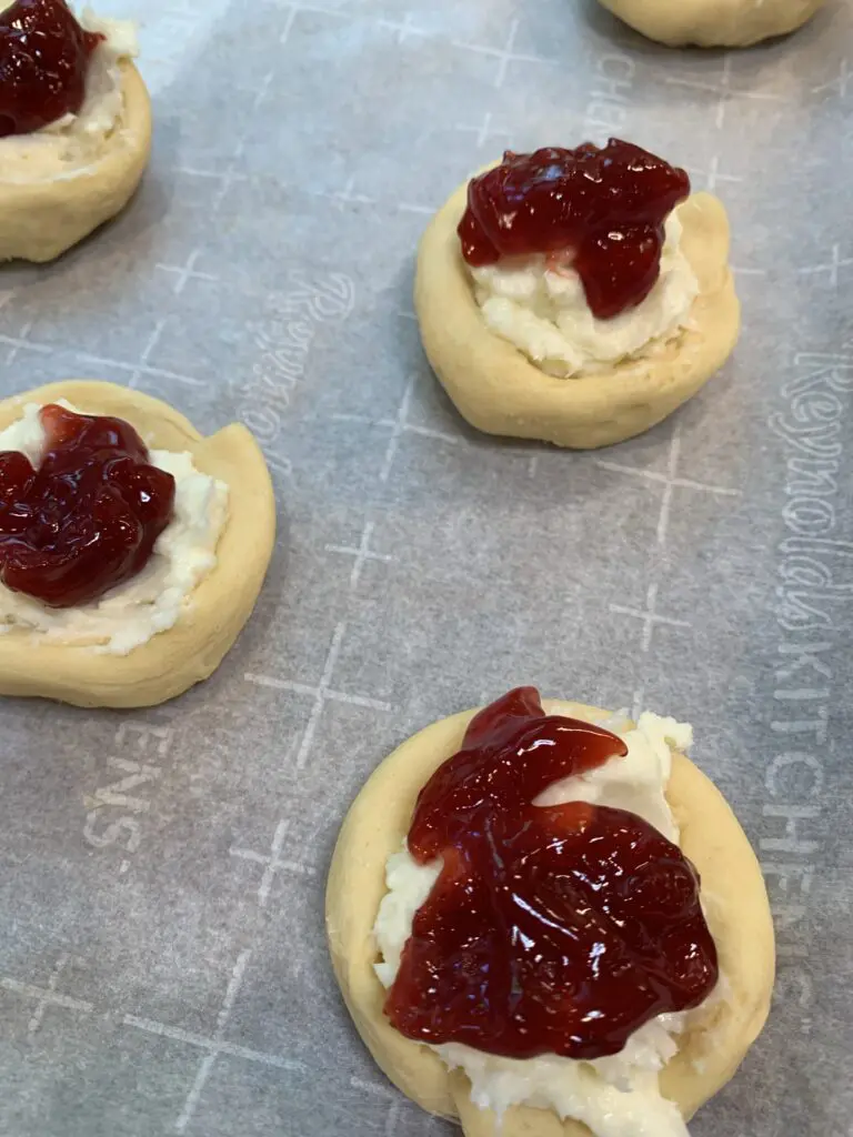 Cherry pie filing on top of the cream cheese