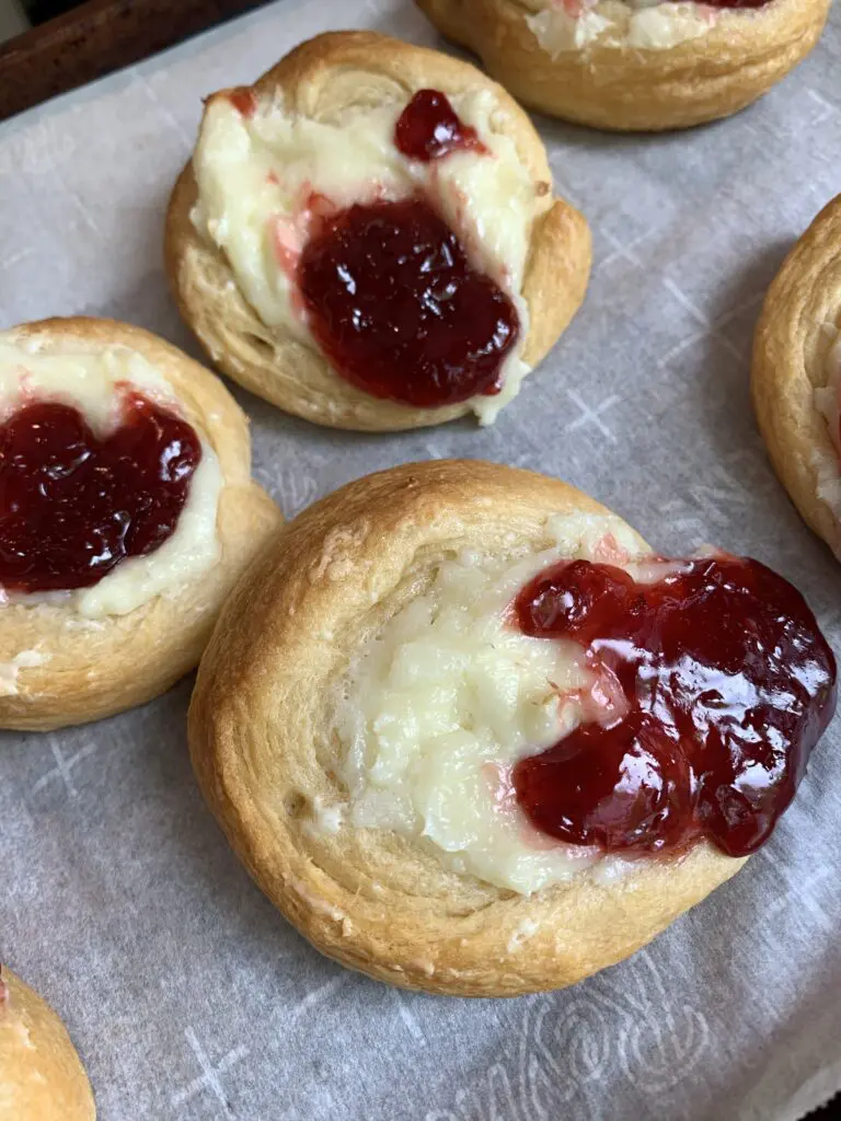 finished cherry danishes on parchment paper