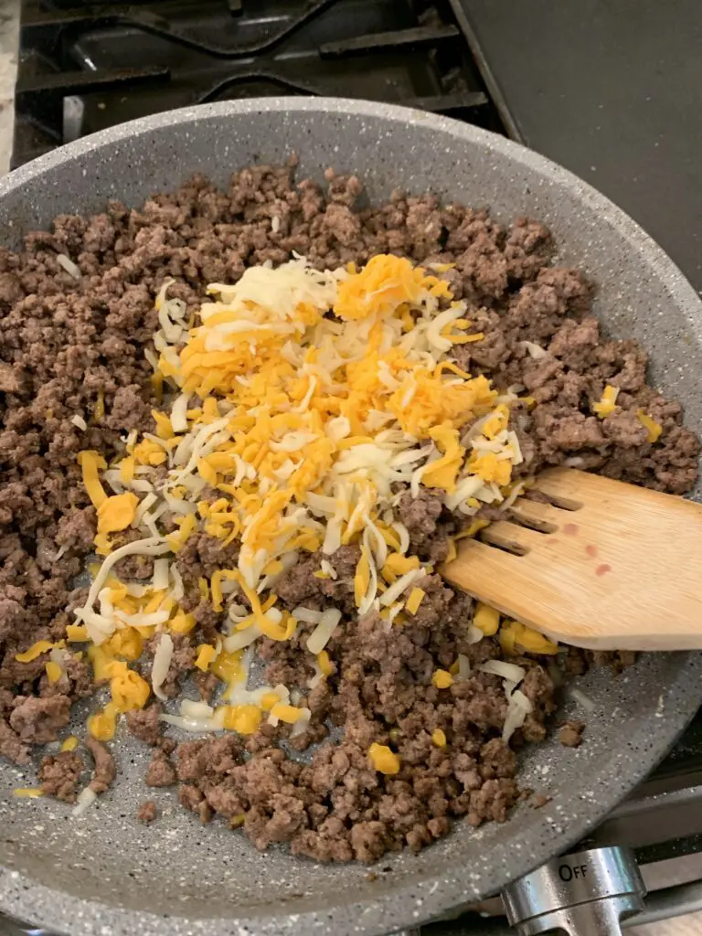 shredded cheese added to ground beef