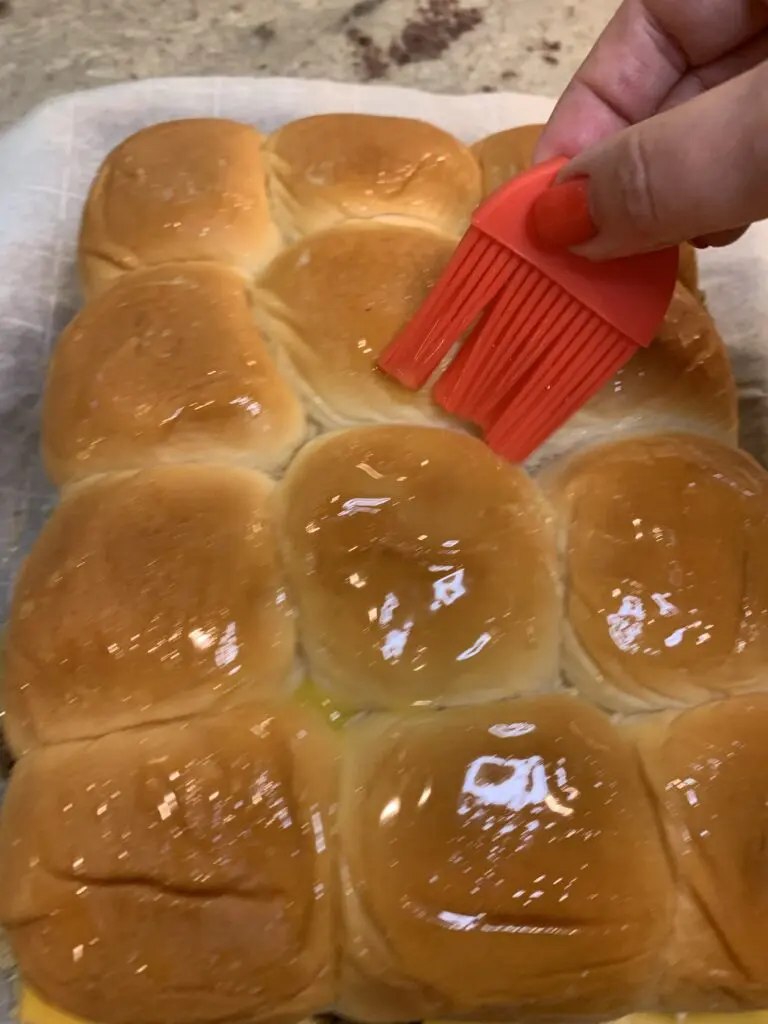 buttering the top of rolls