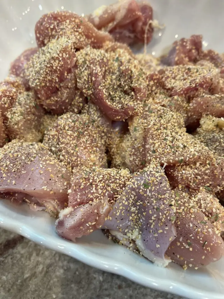 seasoned chicken thighs in a bowl