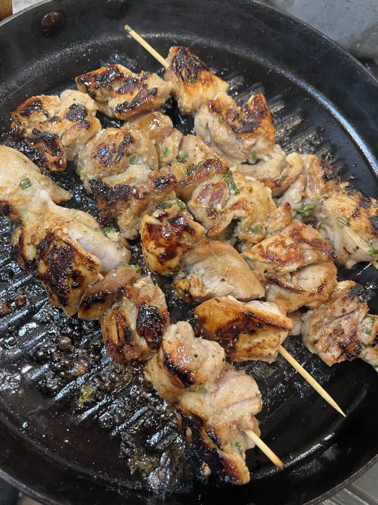 the best chicken marinade being cooked in a grill pan