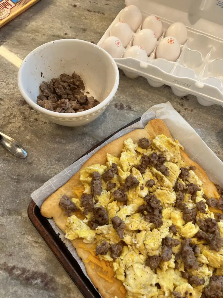 breakfast pizza being made