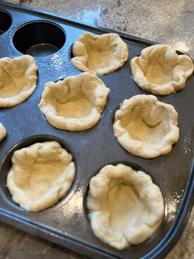 biscuits in sprayed muffin tin