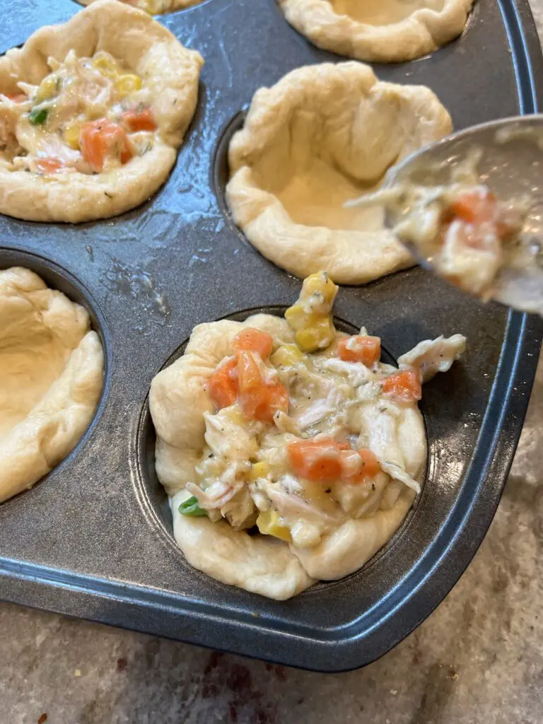 pot pie filling going into biscuit dough