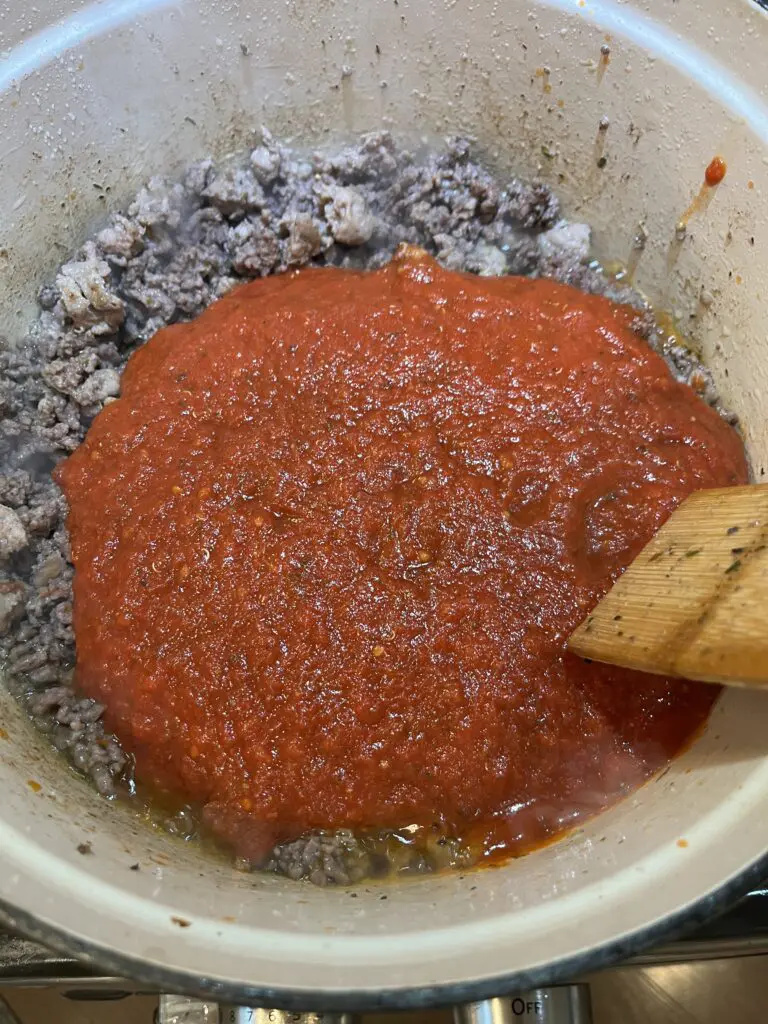 tomato sauce added to browned meat