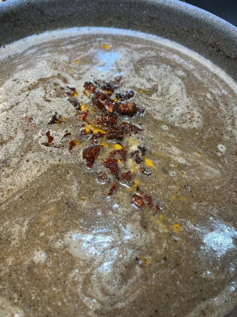 adding sun dried tomatoes in