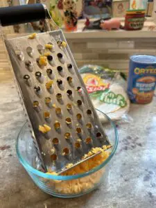 shredding cheddar cheese