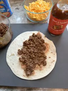 taco seasoned ground beef on top of beans