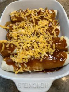 cheese on top of enchelada sauce