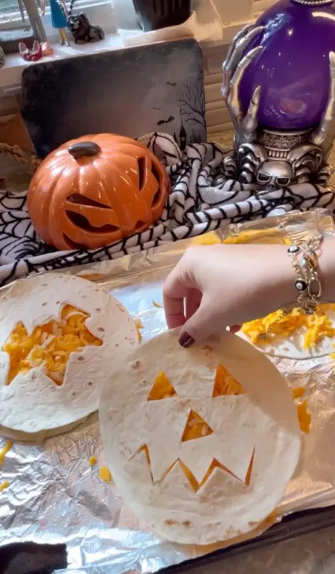 putting cut out tortilla on top of the cheese