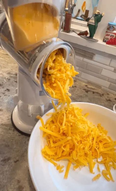 shredding cheddar cheese