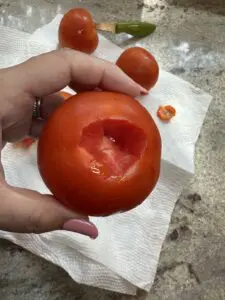 slicing the stem out of the tomato