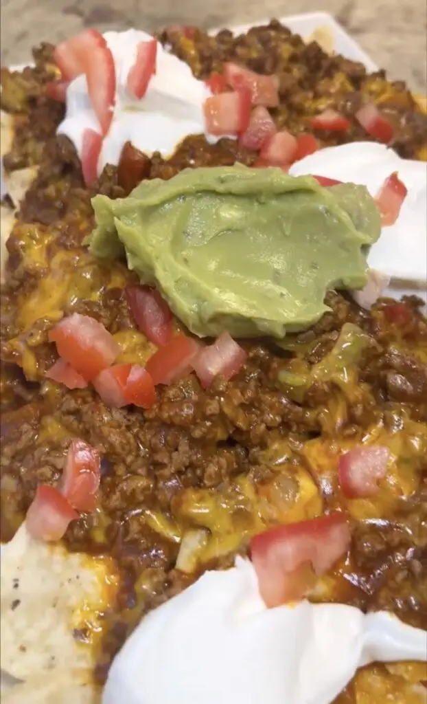 closeup of skillet nachos with guacamole