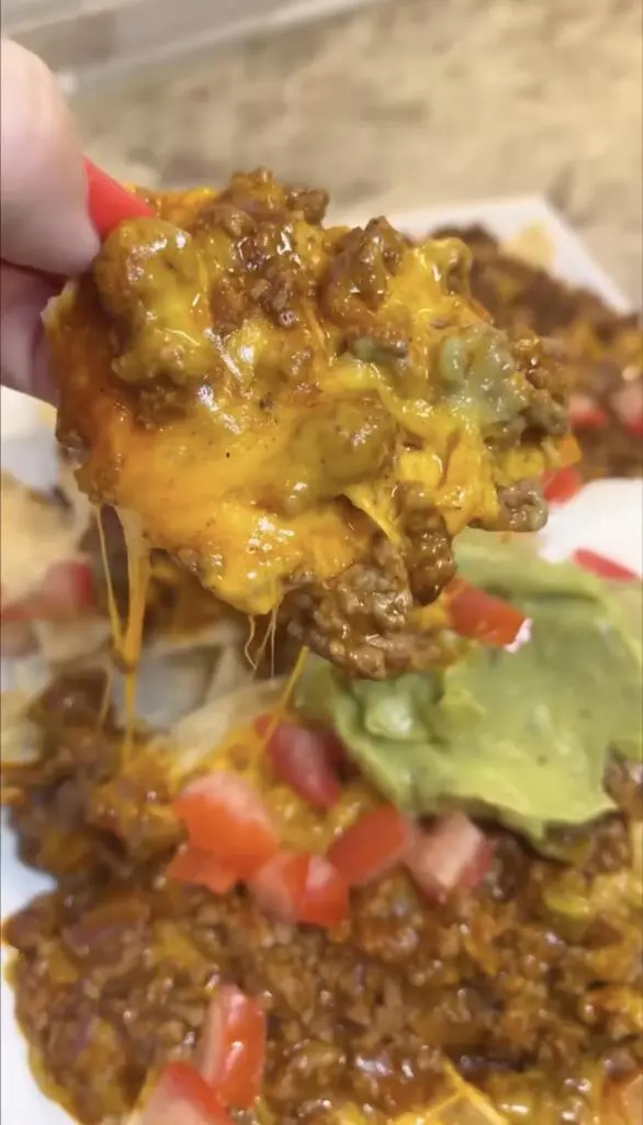 scoop of prepared skillet nachos on tortilla chip