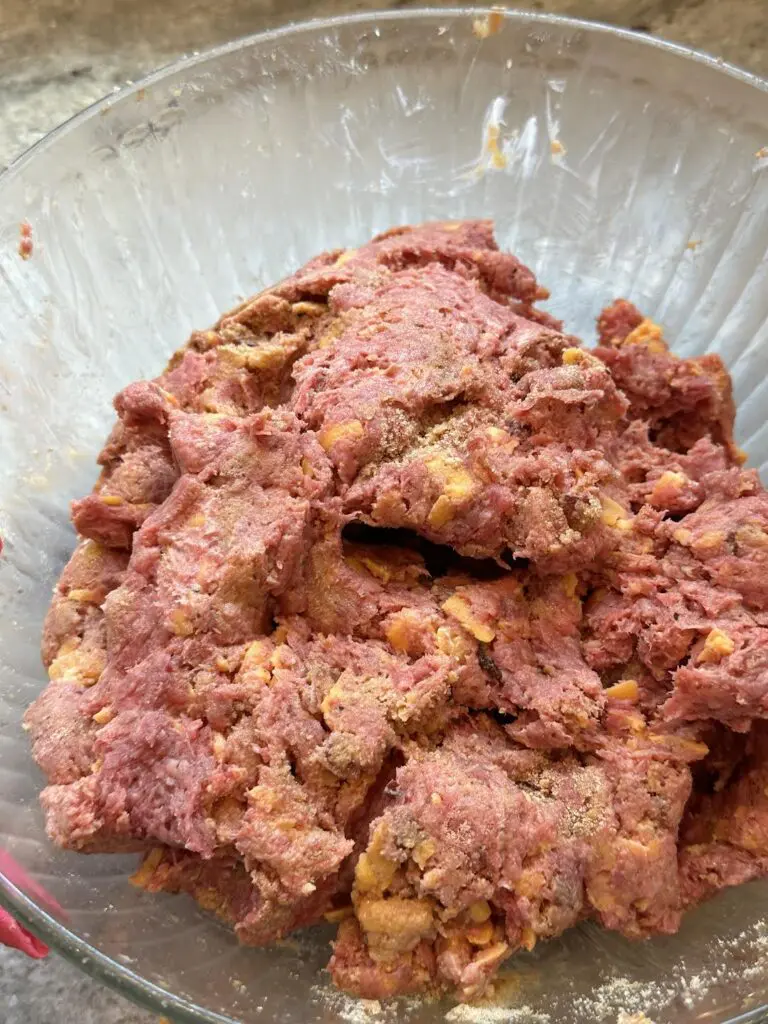 seasoned ground beef, shredded cheese, breadcrumbs, egg in bowl mixed together