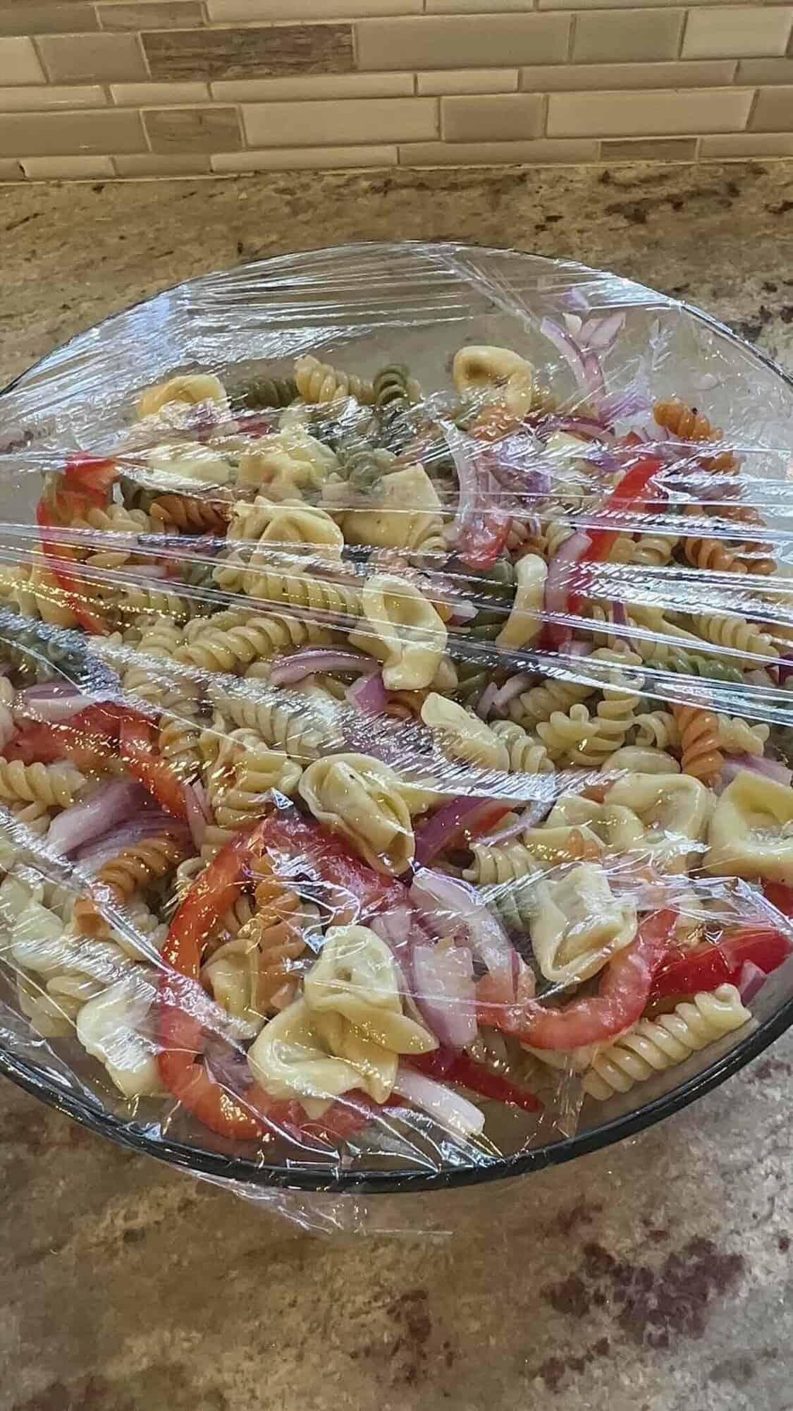 tortellini salad covered and going in the fridge to marinate