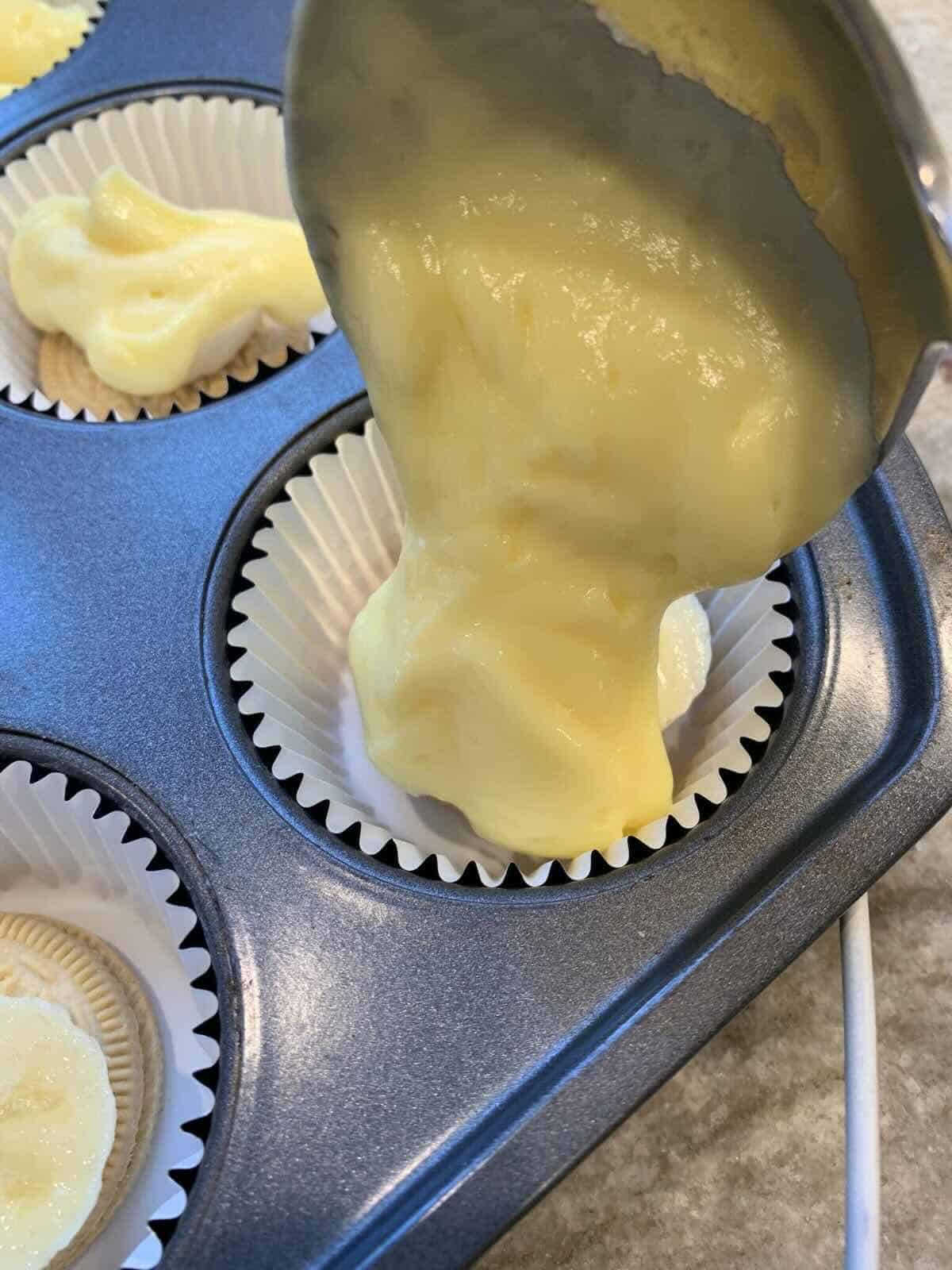 banana pudding going into muffin tin holes
