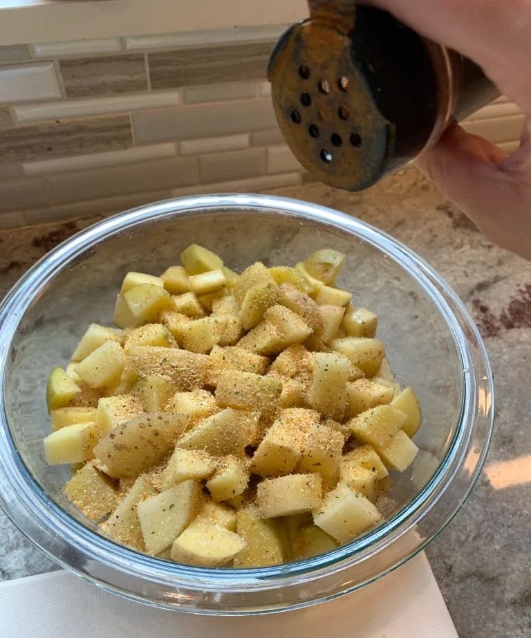 adding paprika to potatoes