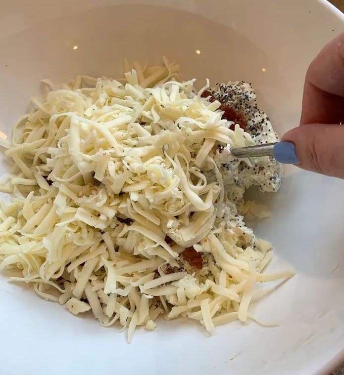 Monterey Jack cheese added to a bowl 