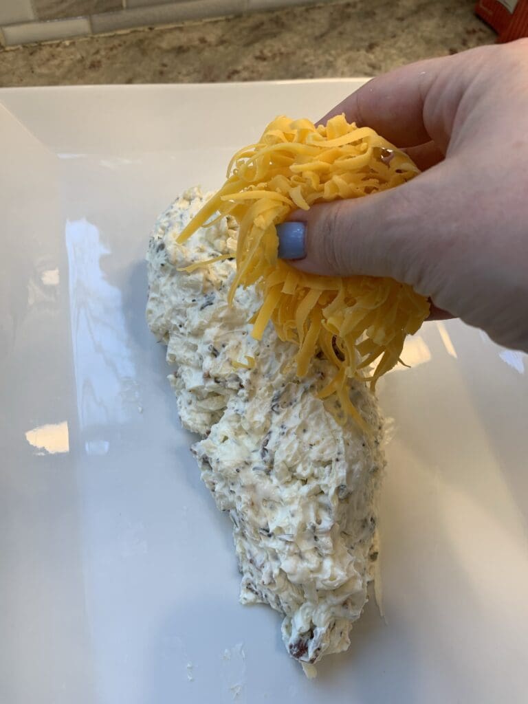 adding cheddar cheese to the cream cheese carrot