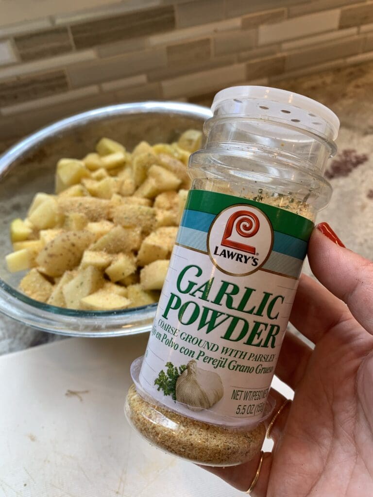 adding garlic powder to potatoes