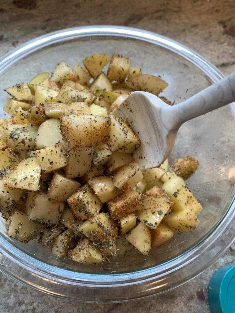 mixing the seasoning into the potatoes