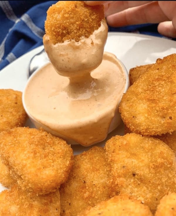 nuggets dipped into sauce