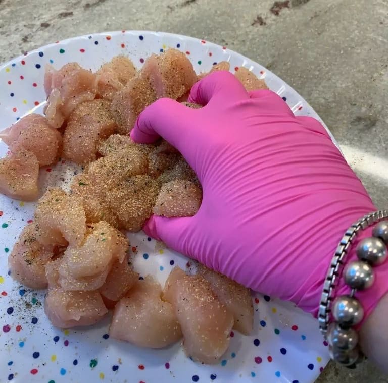mixing seasoning into the chicken