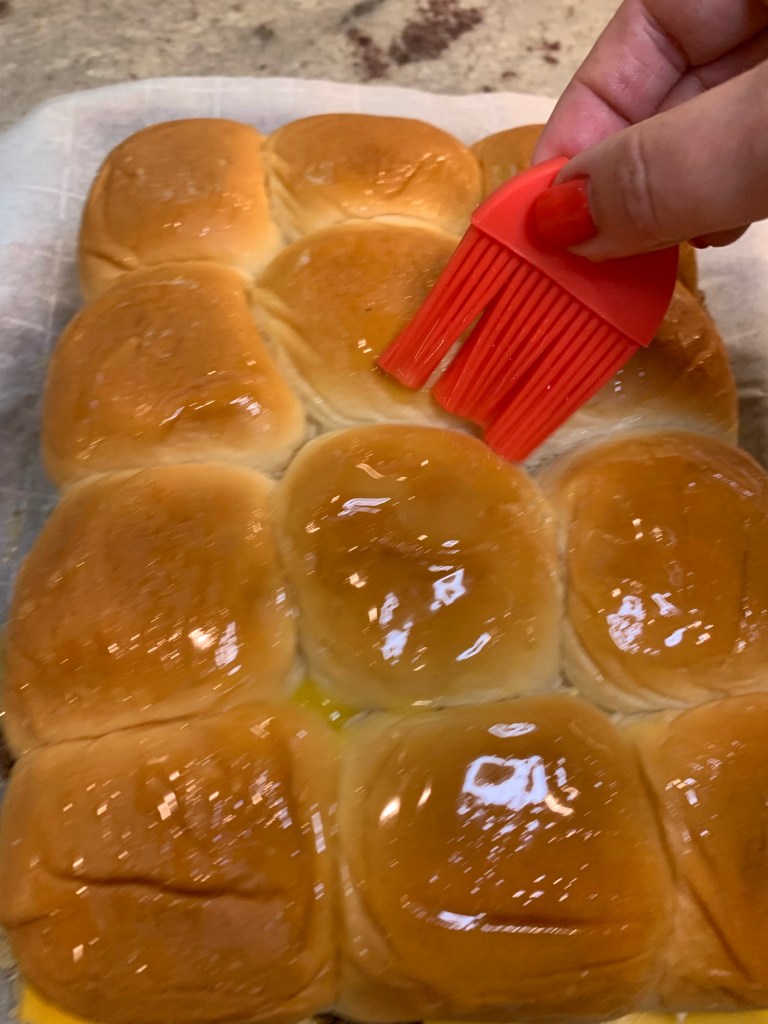 buttering the top of rolls
