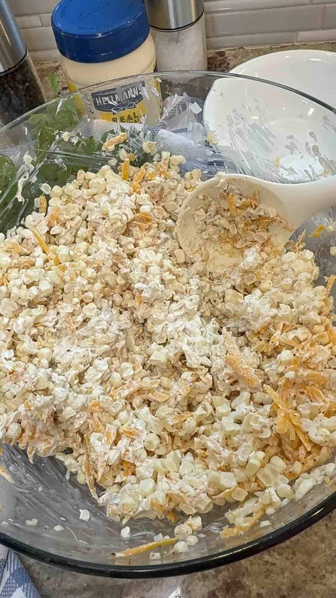 All mexican street corn ingredients mixed together in a bowl.