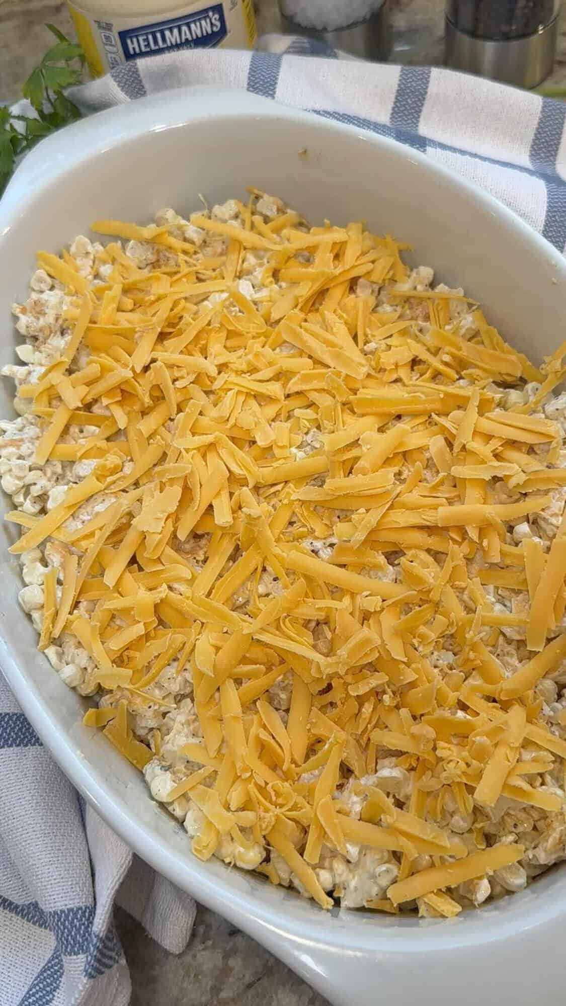 Mexican street corn cassrole with cheese in baking dish