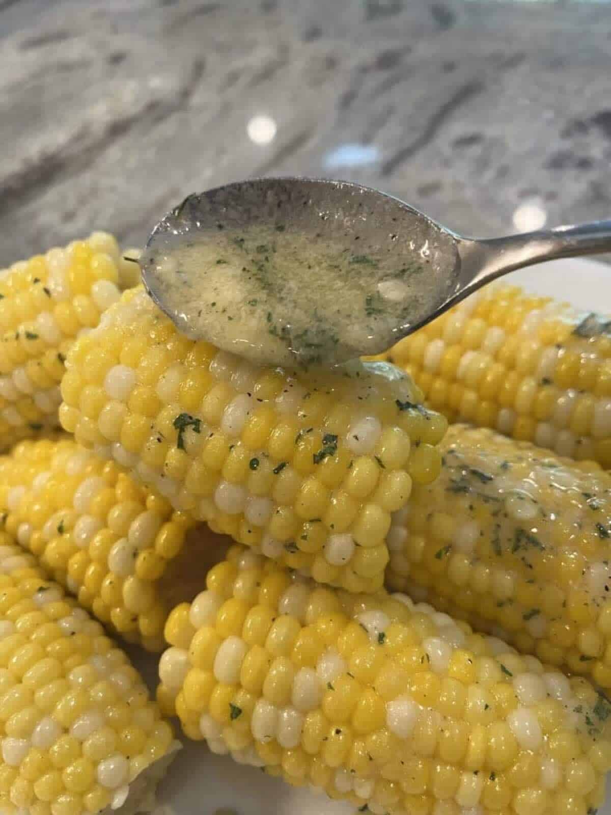 ranch butter being spooned over corn