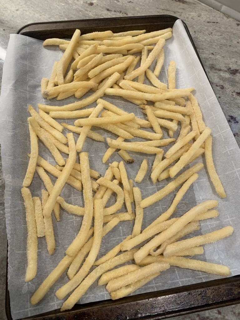frozen fries on baking sheet
