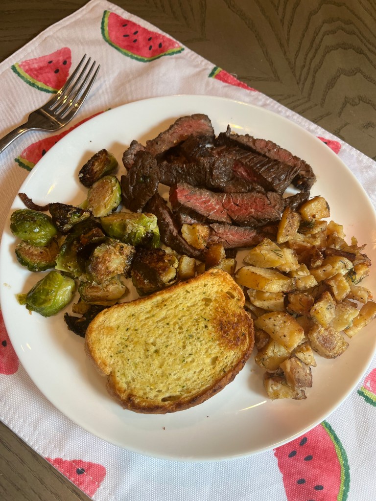 plated dinner of skirt steak, potatoes and Brussels sprouts