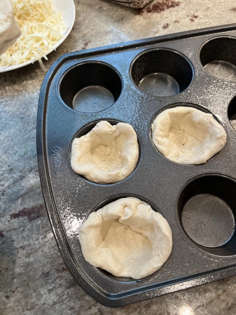 pizza dough in muffin tin