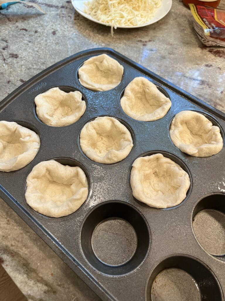 pizza dough in muffin tin