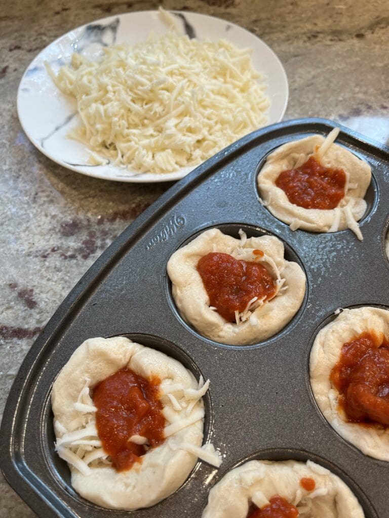 sauce on top of pizza dough