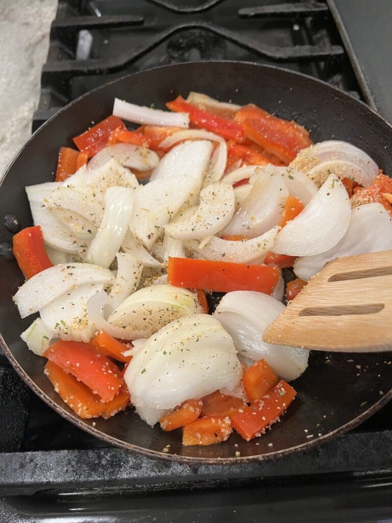 seasoned peppers and onions in skillet