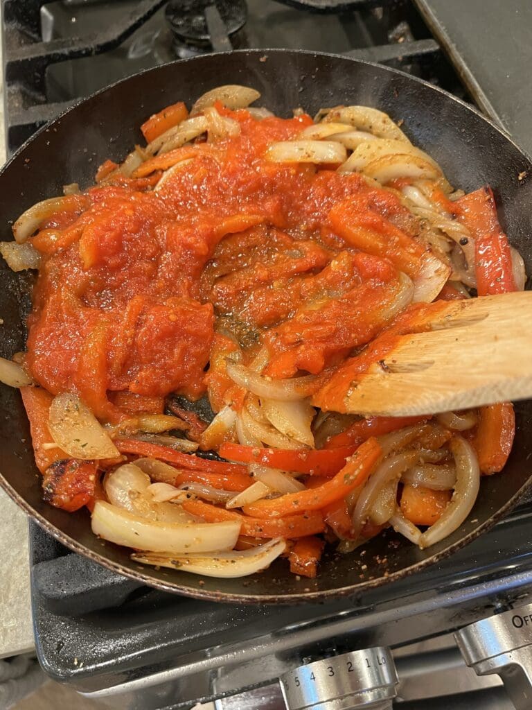 sauce in peppers and onions on skillet