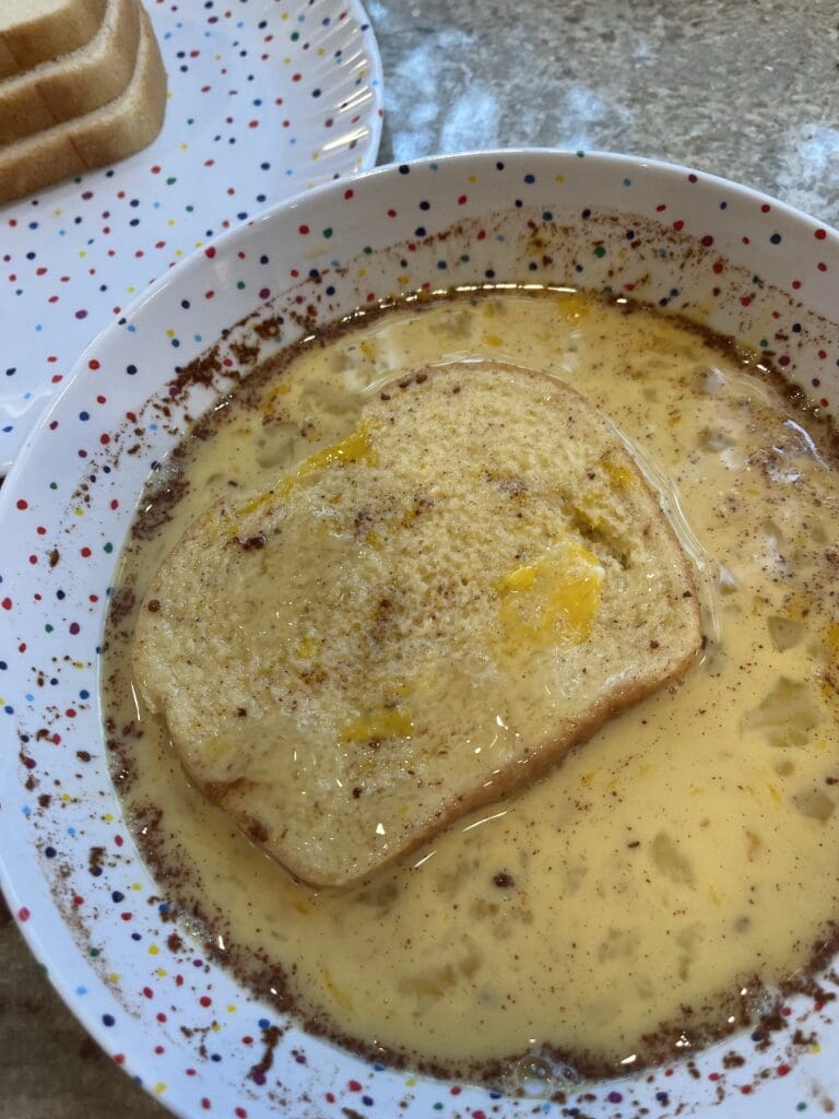 bread soaking in the French toast