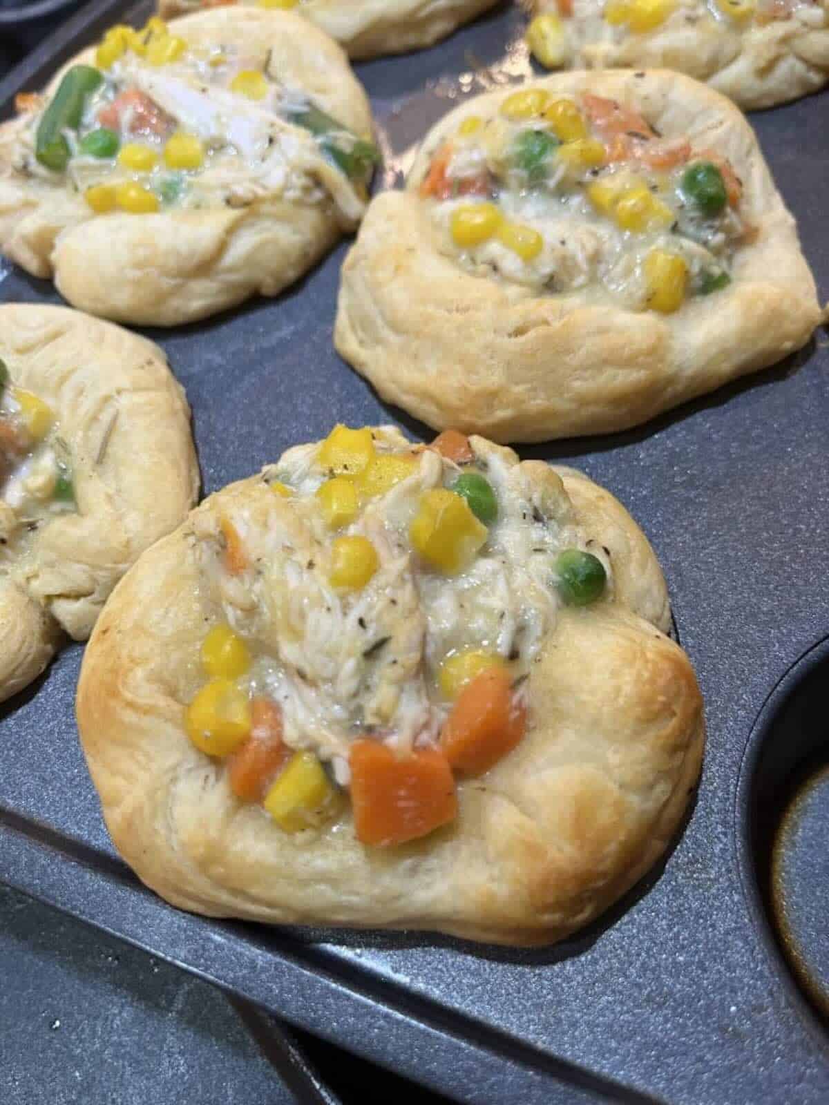 finished chicken pot pie in muffin tin