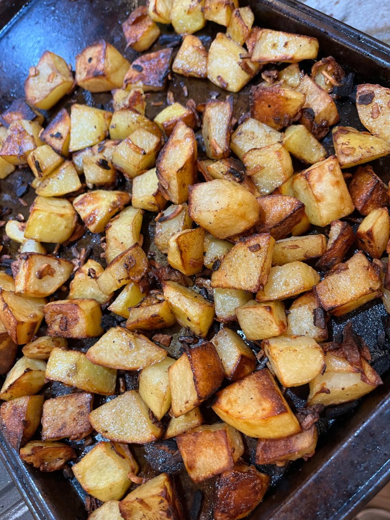 onion roasted potatoes on a baking sheet