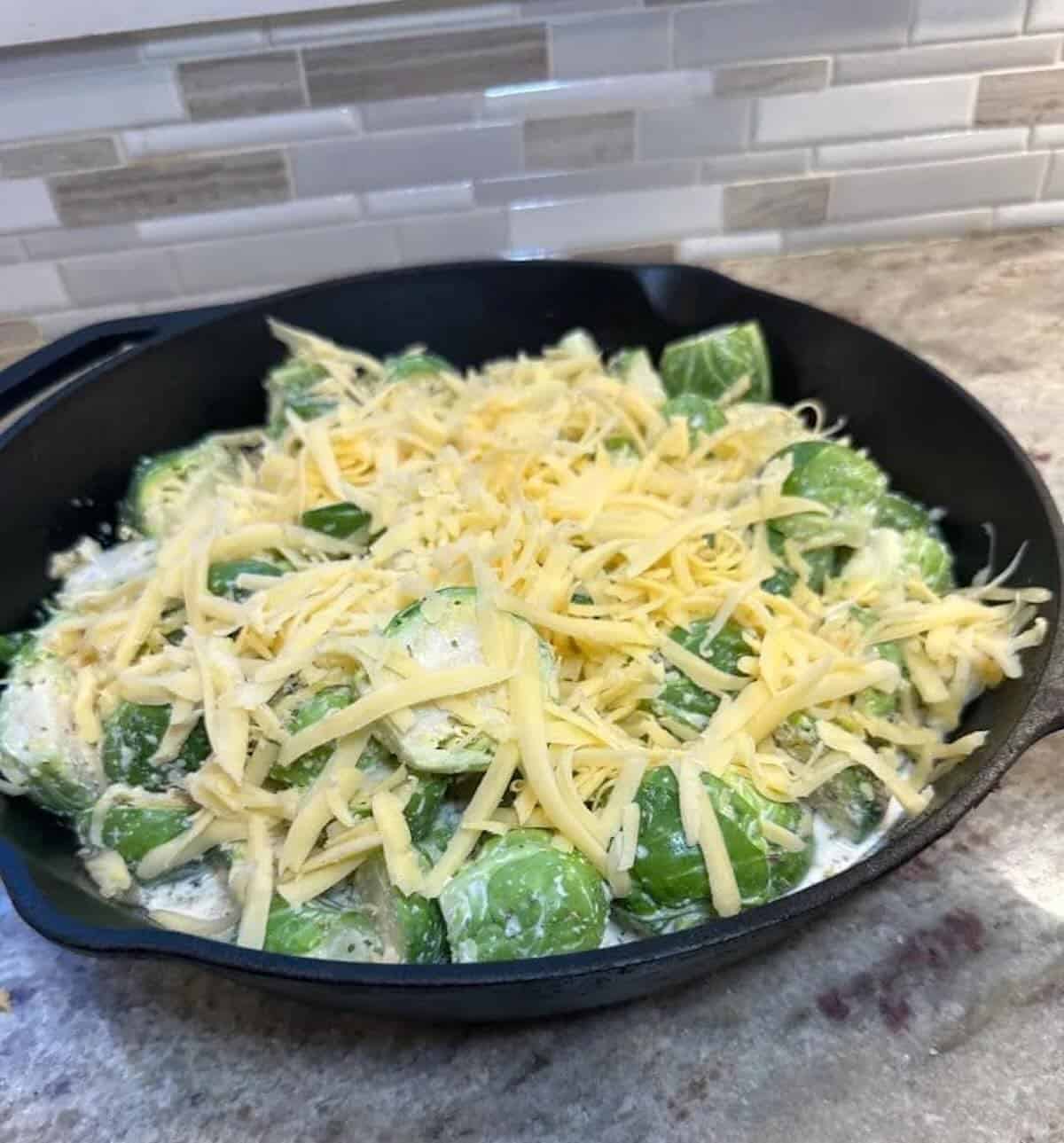 brussels sprouts topped with cheese in baking dish