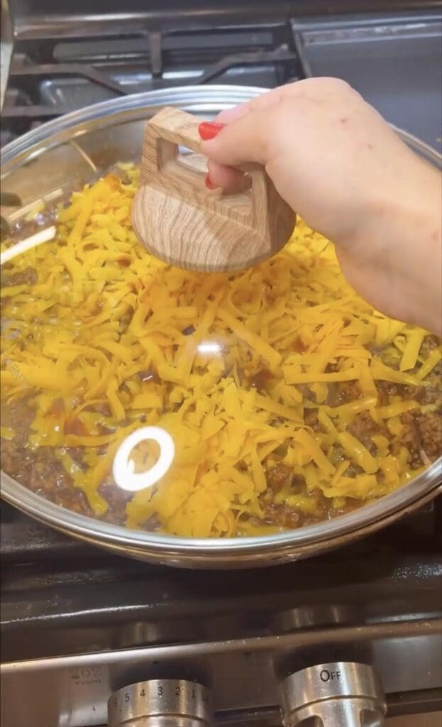 putting lid on skillet nachos while on stove