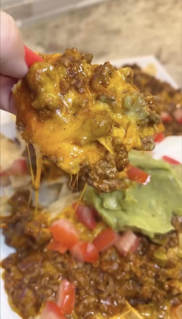 scoop of prepared skillet nachos on tortilla chip