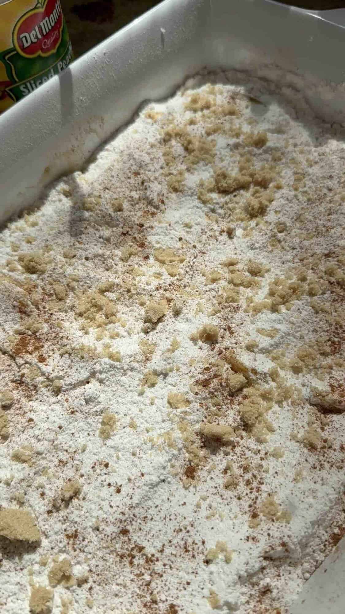 peaches, cake mix and brown sugar in baking dish