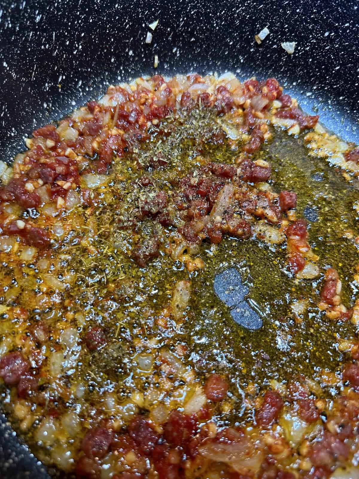 pancetta and onions sauteing in pan